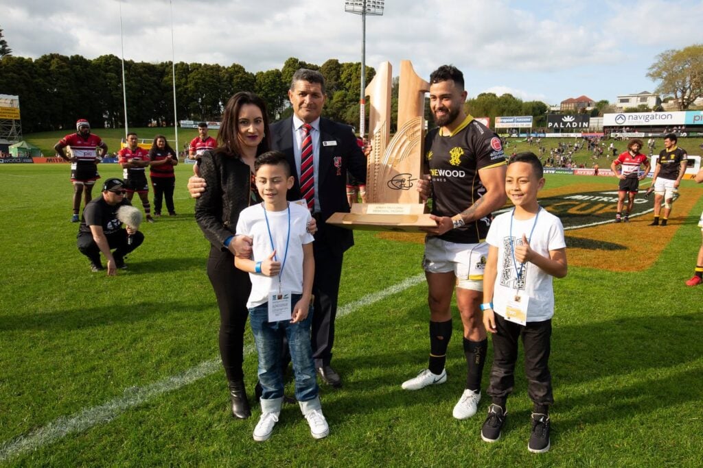 Group at a rugby trophy presentation, supplied for Kere Maihi’s profile