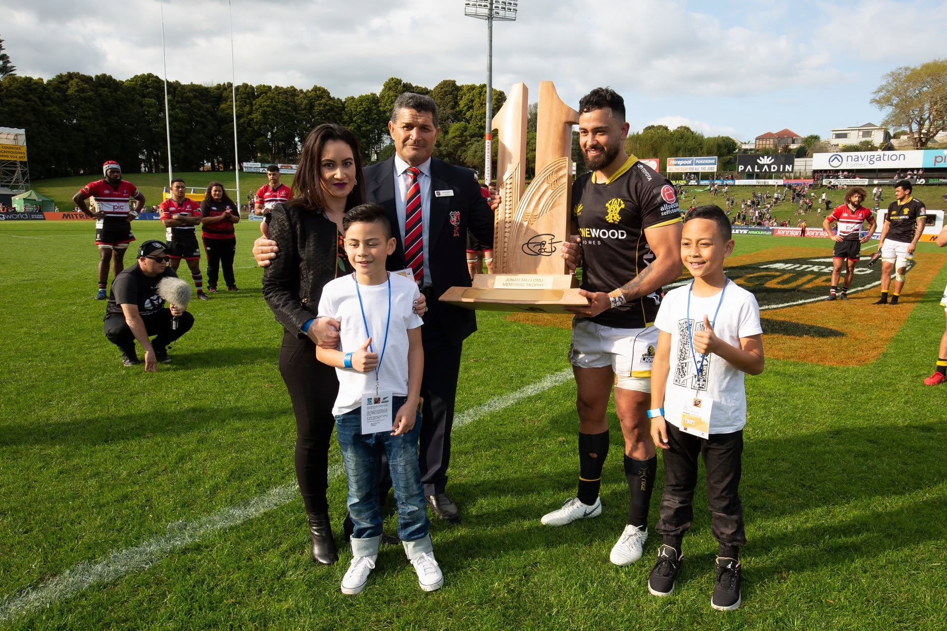 Group at a rugby trophy presentation, supplied for Kere Maihi’s profile